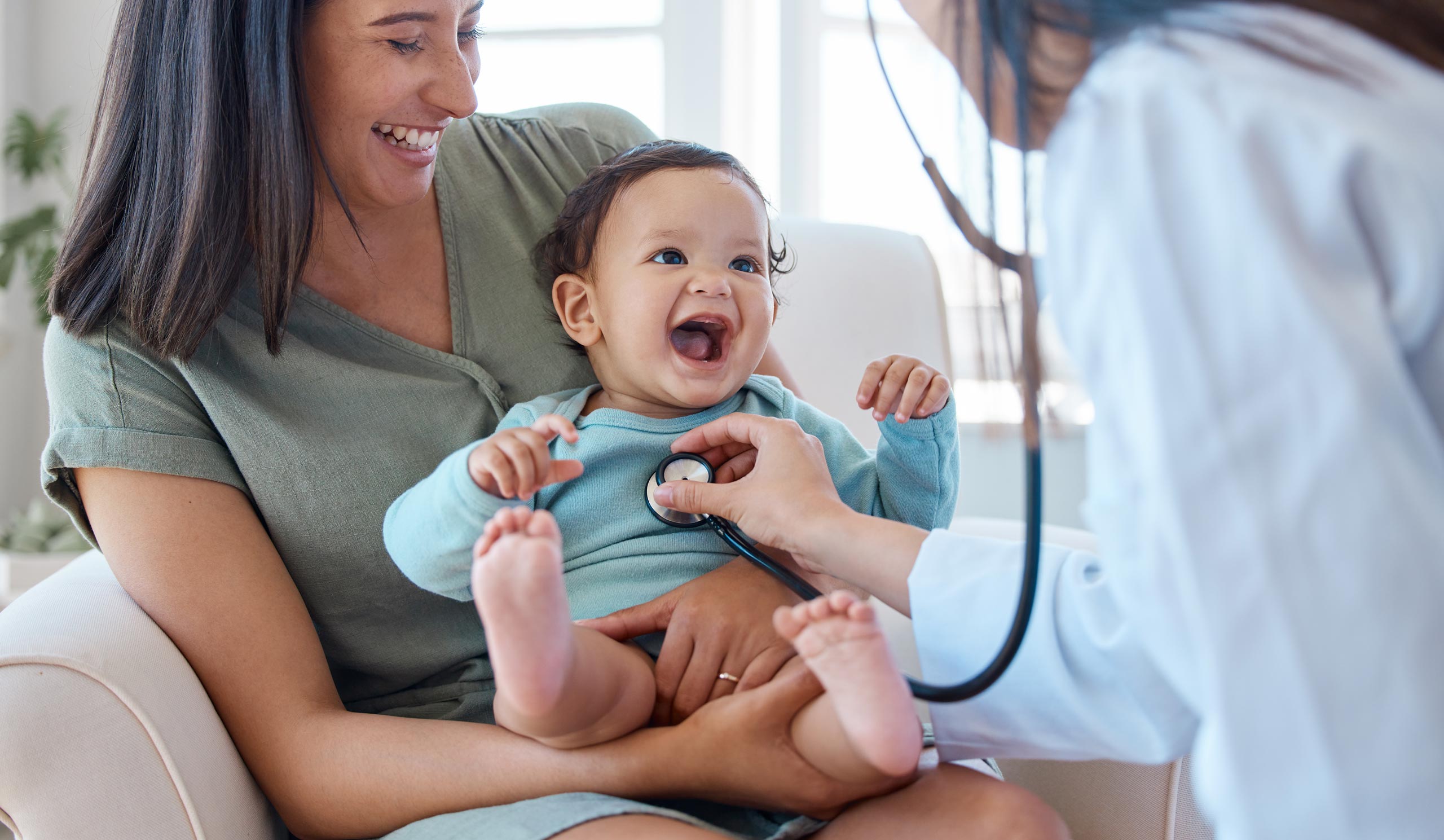 laughing mother and child at a doctor